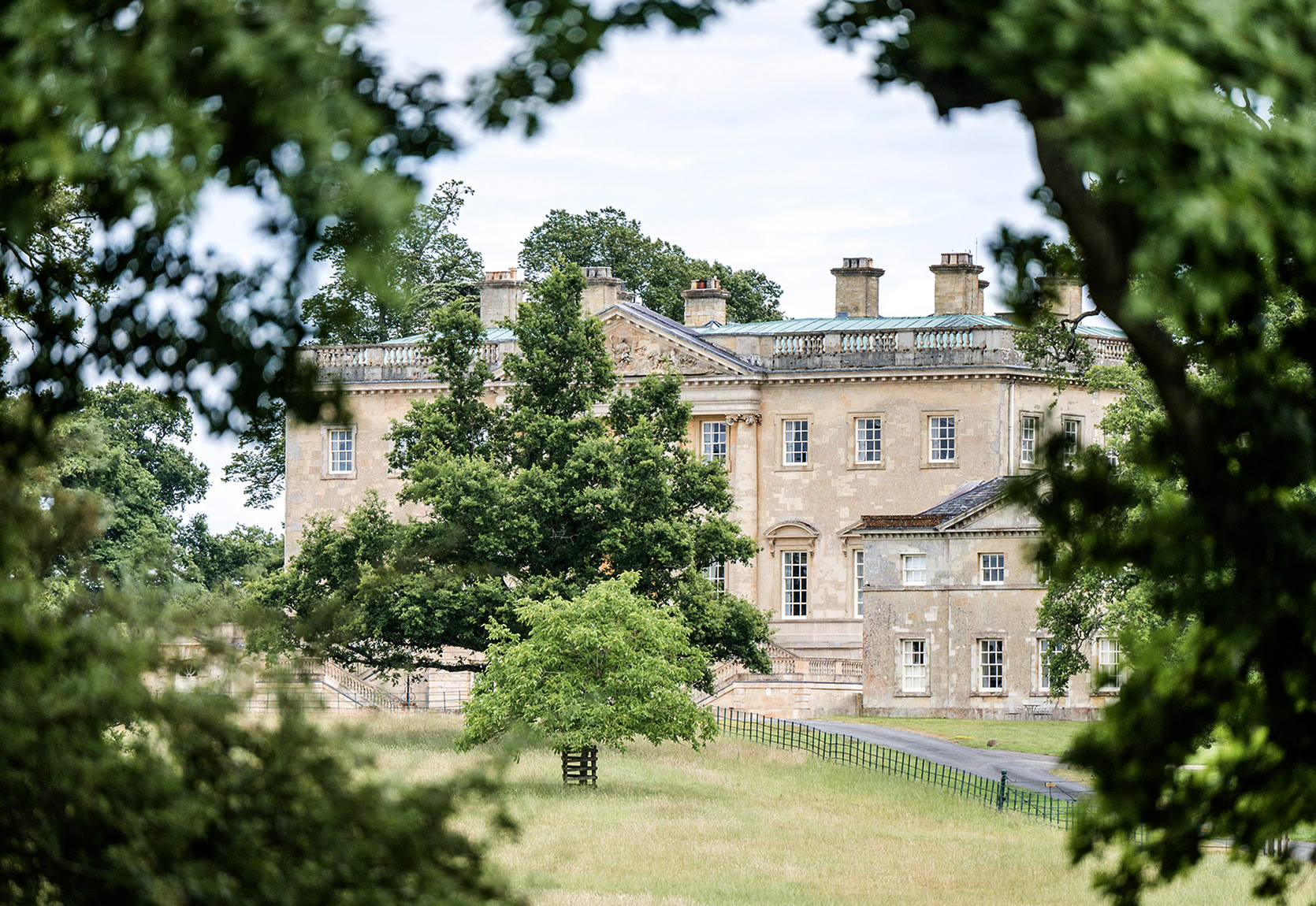 A view through the trees with Kirtlington Park in the background