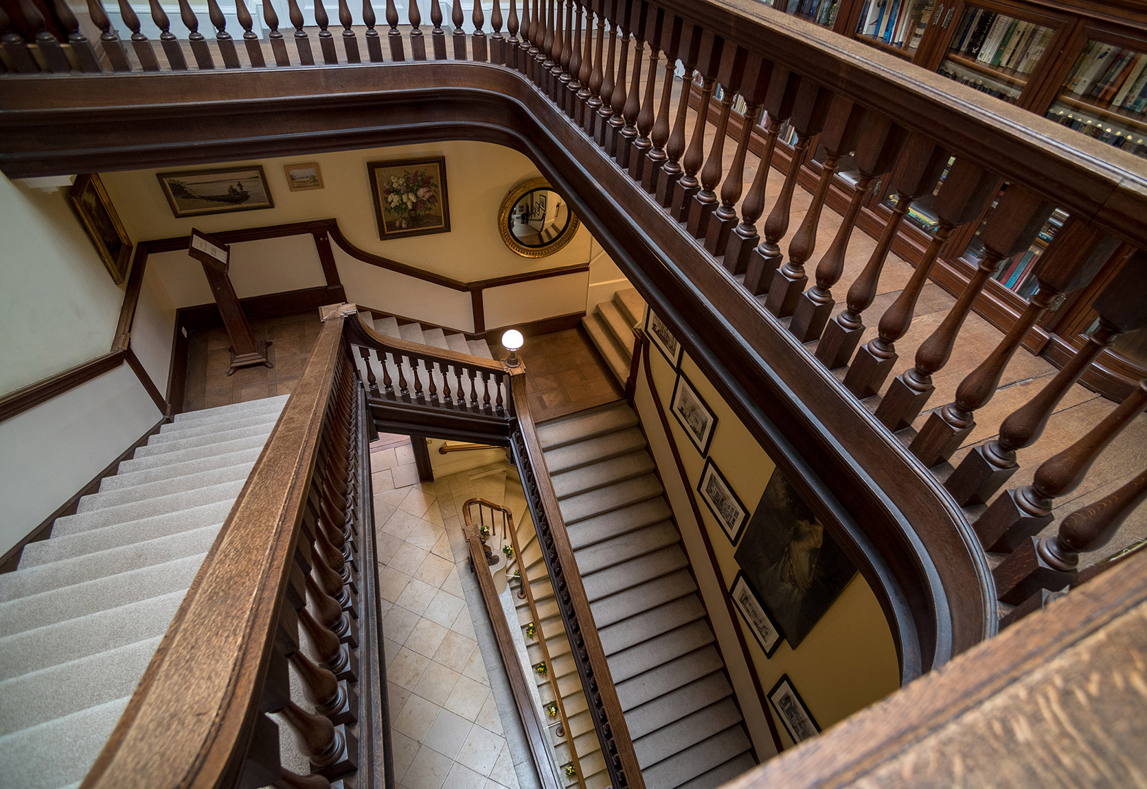 A winding, wooden Period staircase within Kirtlington Park house