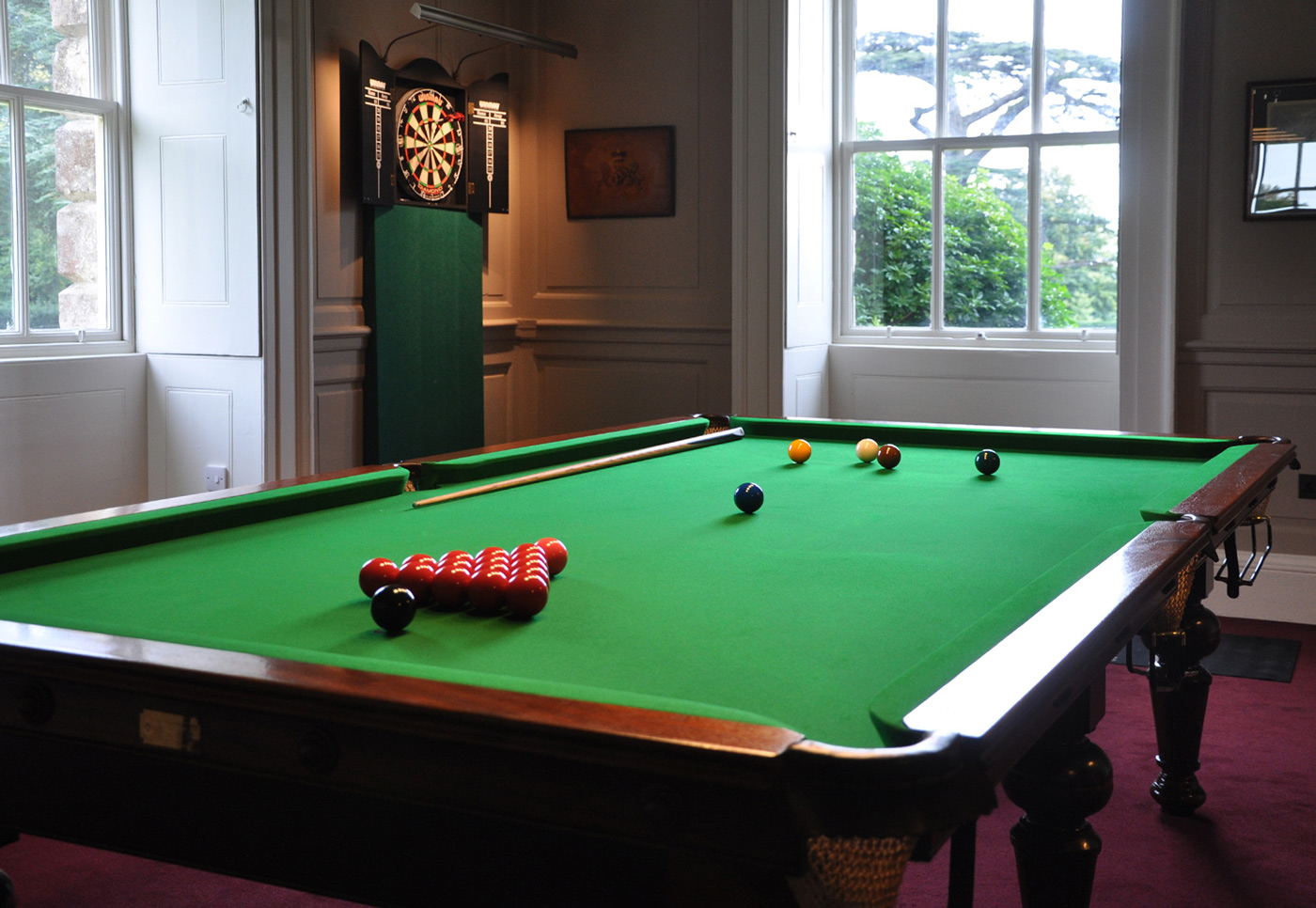 Snooker table and dart board in the Billiard Room