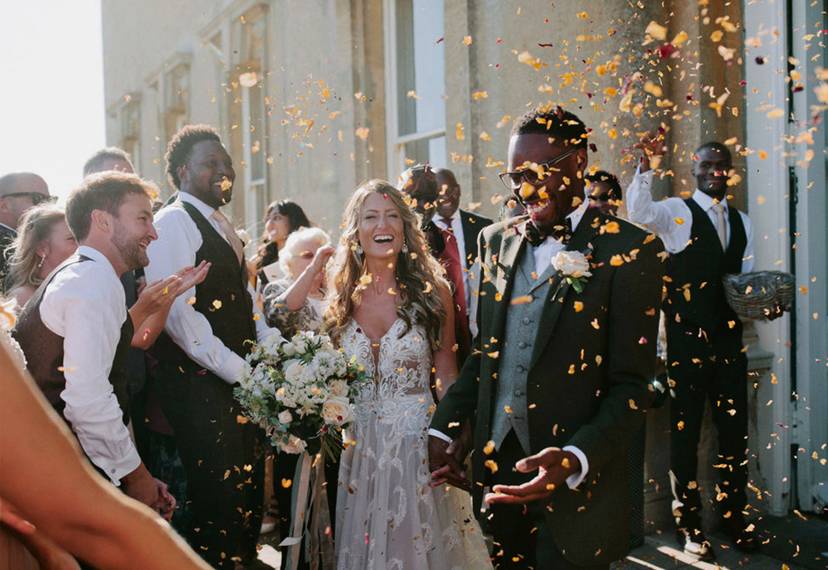 Wedding couple celebrate within the grounds of a country house in Oxford