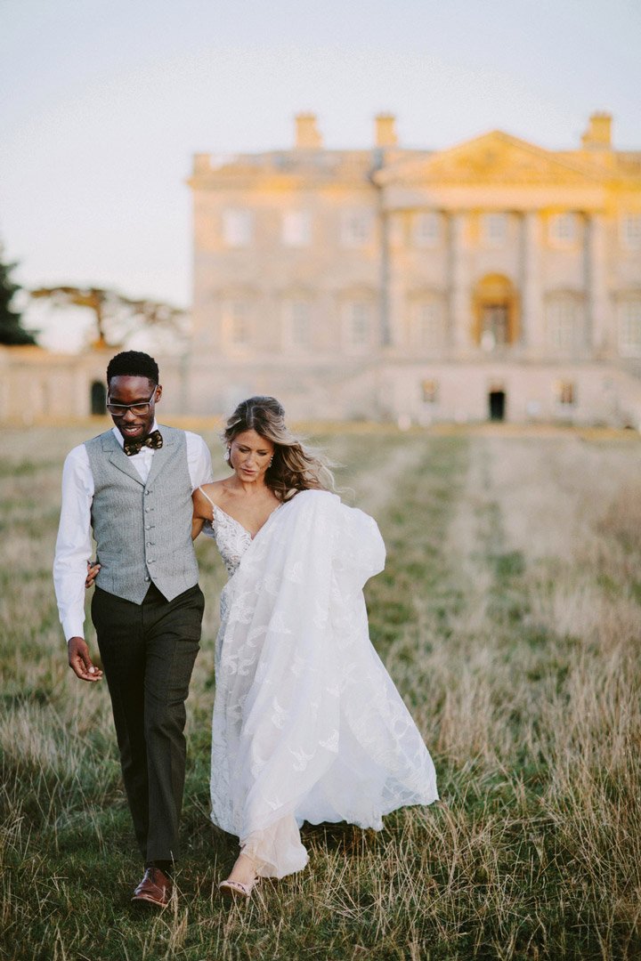 Wedding couple celebrate within the grounds of a stately home wedding venue in Oxford